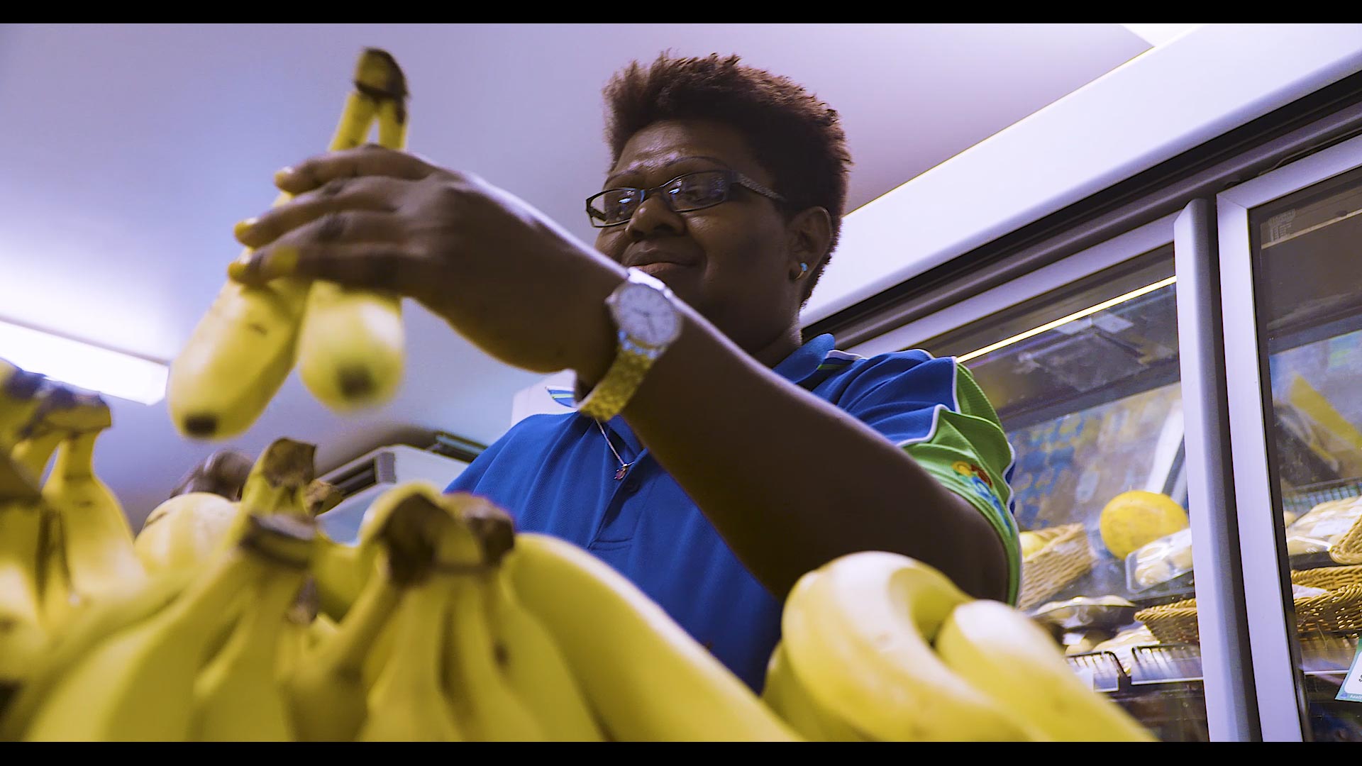 Ibis team member stacking bananas